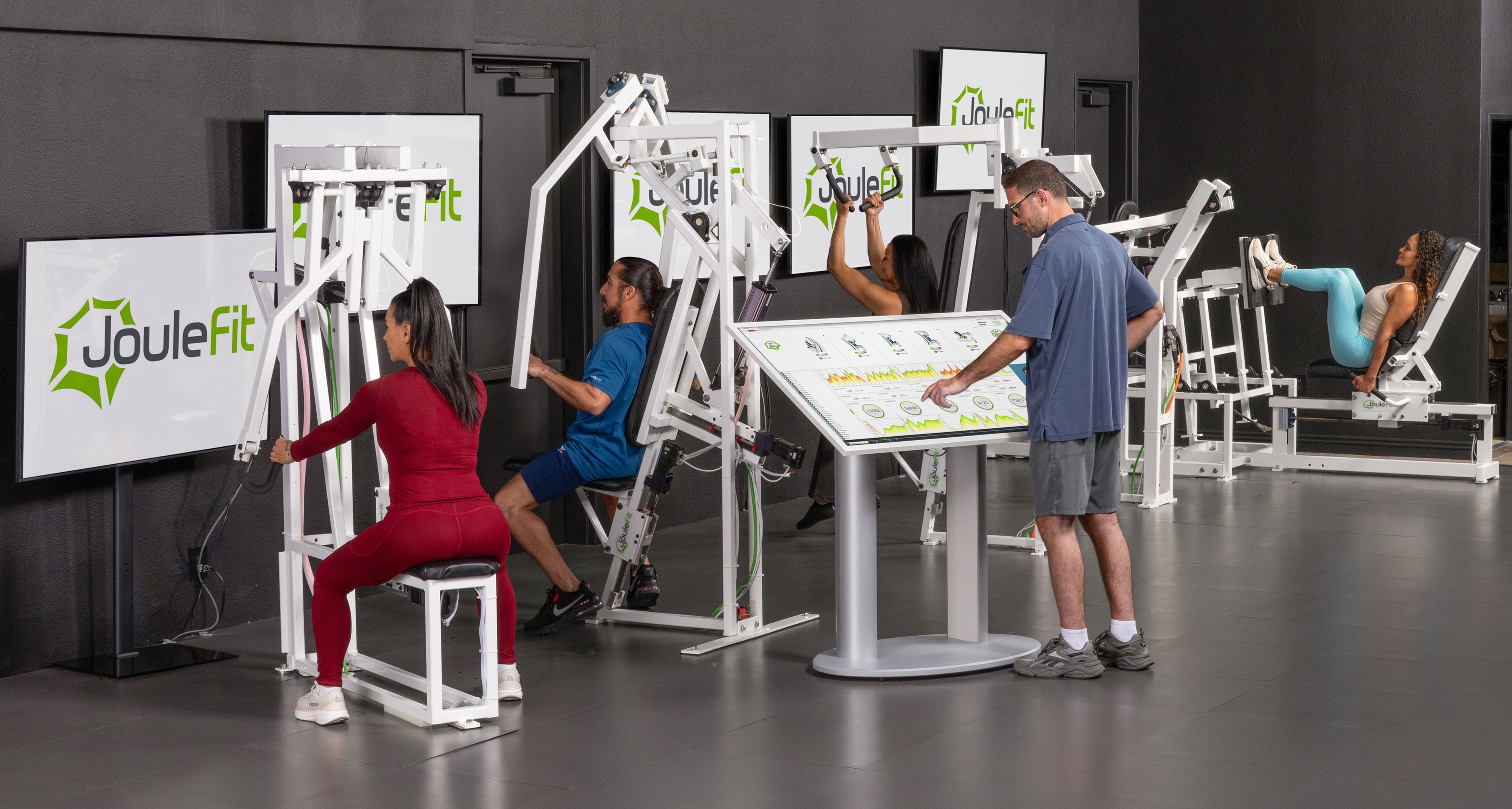 JouleFit AI-powered performance center with people training on robotic machines